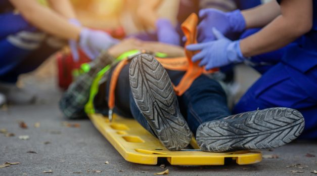 Selective focus shoe . Team paramedic firs aid accident on road. Ambulance emergency service. First aid procedure.