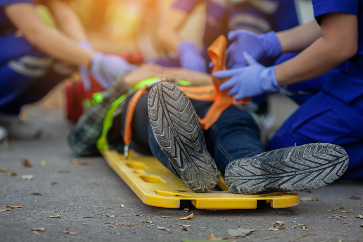 Selective focus shoe . Team paramedic firs aid accident on road. Ambulance emergency service. First aid procedure.
